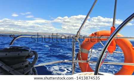 Picture taken on a sailing boat. The sun is shining, the sea is blue, the sky is mostly clear