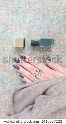 Female hands with long nails with green nail polish