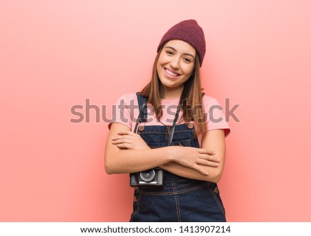 Young cute photographer woman crossing arms, smiling and relaxed