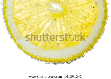 Lemon Slice in Clear Fizzy Water Bubble Background Isolated Royalty-Free Stock Photo #141391243