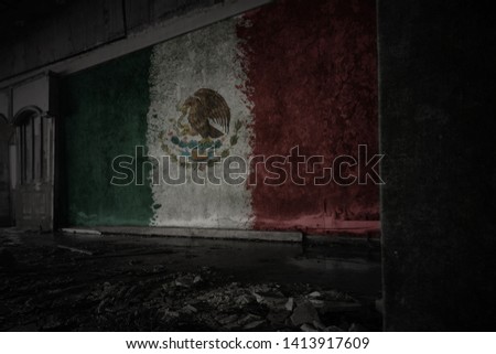 painted flag of mexico on the dirty old wall in an abandoned ruined house. concept
