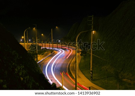 curved road at night, in Lima Peru, after riding with my bicycle for around an hour looking for a good spot to shoot long exposure and also a spot where thiefs are not going to steal my gear 