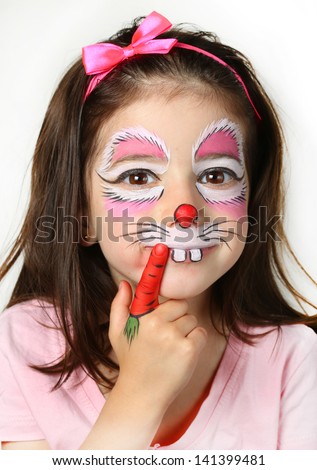 Pretty girl with face painting of a bunny. Royalty-Free Stock Photo #141399481