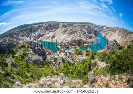 Canyon in Croatia on the background of blue sky with clouds. Krka National Park. The river at the bottom of the picturesque canyon. Beautiful places in Europe. Travel to interesting places.