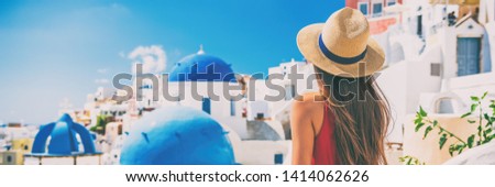 Santorini vacation honeymoon girl enjoying view of 3 blue domes famous tourist attraction in Europe. Banner panorama.