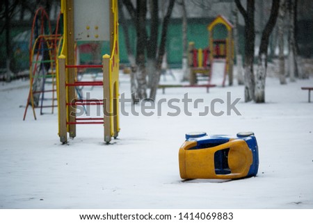Playground covered with snow. Yard playground in the winter.
