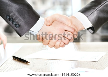 close up. handshake business partners after signing the contract.