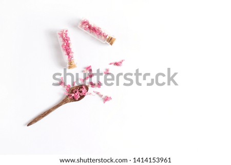 composition from flowers and small glass bytylochek on a white background. copy space, flat lay.