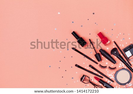 Set of decorative cosmetic and beauty products for makeup on star confetti background top view. Flat lay.