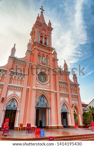 Amazing view of gorgeous facade of Da Nang Cathedral on blue sky background at downtown of Danang, Vietnam. The Pink Catholic Church is a popular tourist attraction of Asia.