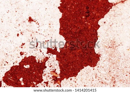 Old asphalt surface painted with white paint red color toned close up. Abstract background 