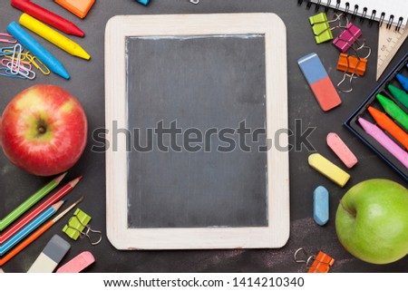 School education supplies on chalkboard backdrop. Back to school template concept. Top view flat lay with copy space for your text