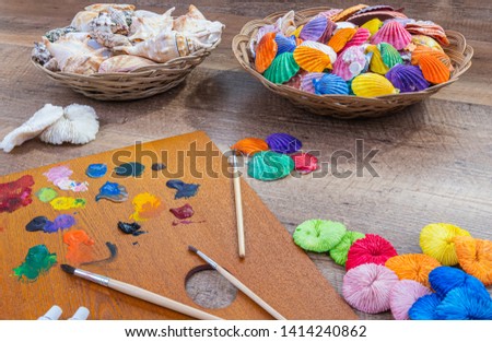 Beautiful composition of painted sea shells and wood background . Abstraction, sea theme, nature, travel, science, beauty.