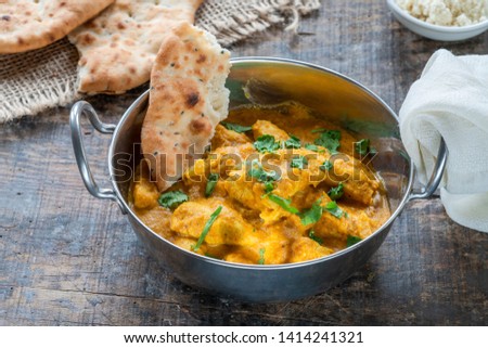 Chicken korma curry with naan bread - high angle view Royalty-Free Stock Photo #1414241321