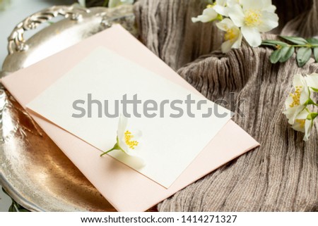 cloth and invitation card in envelope with jasmine flowers and sealing wax. flat lay. wedding invitation