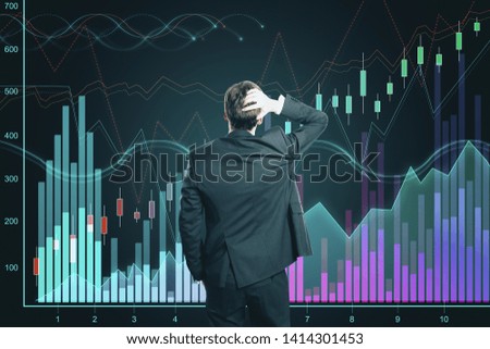 Back view of young businessman looking at dark background with glowing forex chart. Increase and finance concept