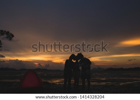 family holding hands 3 people
sunset silhouette on the beach

