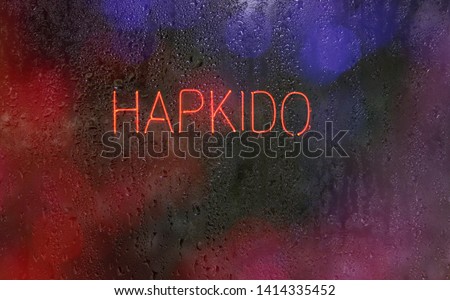 Neon Hapkido Sign in Wet Window