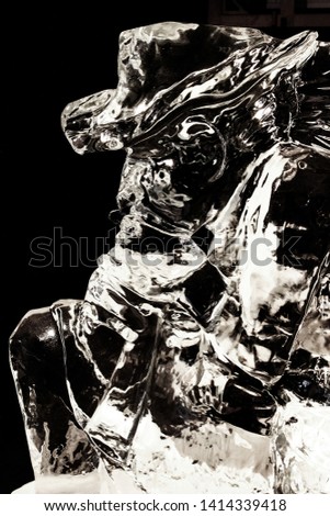 Ice sculpture of a cowboy on a black background