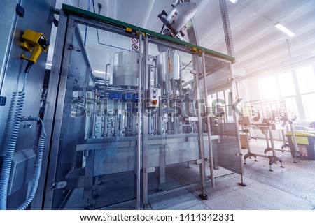 Bottling line of sunflower oil in bottles. Vegetable oil production plant. High technology. Industrial background