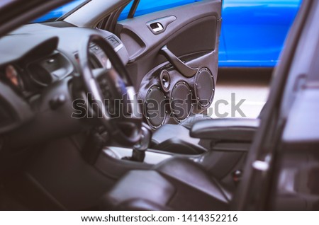 Car Audio System Speakers in the Open Door. Blurred Car Leather Interior. Royalty-Free Stock Photo #1414352216