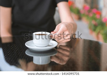 White coffee cup on wooden table in coffee shop blur interior background