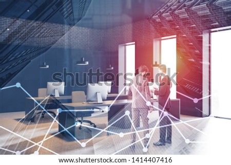 Rear view of two businessmen discussing documents in gray and brick open space office with double exposure of graphs. Concept of stock market. Toned image