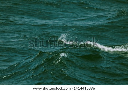 Blue water on the surface of the Pacific Ocean. Natural background. Toned.