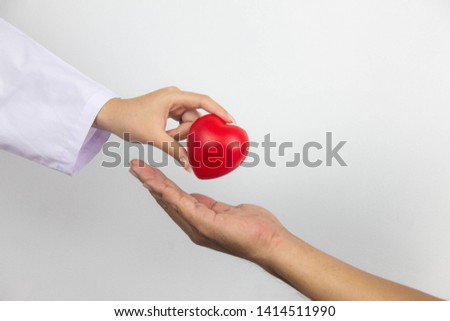 The young woman holding a red heart is being presented to the man - the encouragement concept