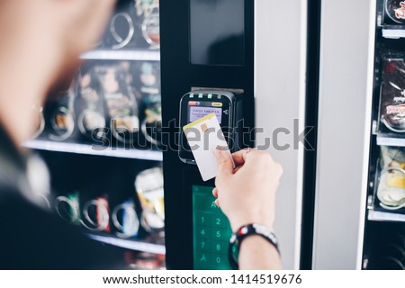 Student using the contactless payment method in a vending machine. Royalty-Free Stock Photo #1414519676
