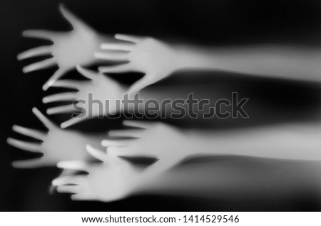 shadow of a hands behind transparent paper