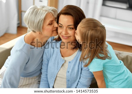family, generation and female concept - daughter and grandmother kissing happy mother at home