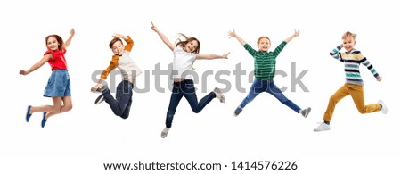 childhood, fun and motion concept - happy children jumping over white background Royalty-Free Stock Photo #1414576226