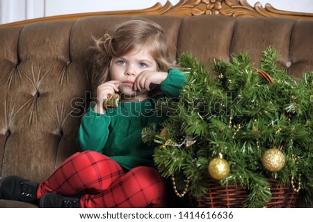 little girl with a Christmas garland