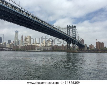 Manhattan bridge and building in the evening view from river, New York City.
