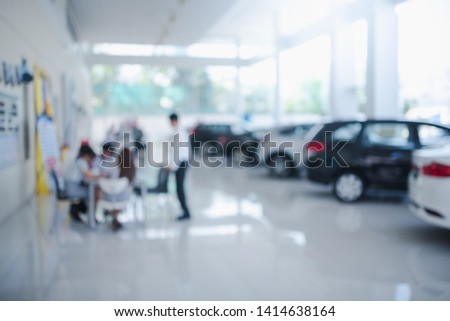 Blurred dealership store, with the cars and soft lightning., new car pictures in the showroom,  show waiting for sales of branch dealers and new car service centers.
