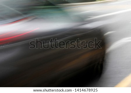 Automobile driving fast in an urban road