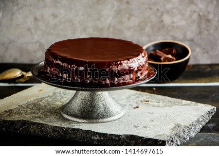 Homemade dark chocolate cake on cake stand close up