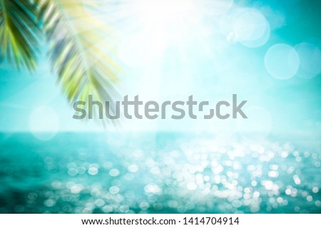 Blurred summer background of free space for your decoration and palm leaves with sun light.  Royalty-Free Stock Photo #1414704914