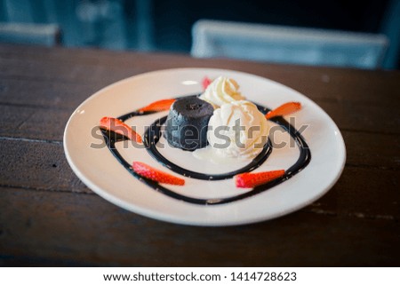 The picture of hot chocolate lava cake with vanilla ice cream and fresh strawberry