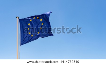 European Union Flag waving in the wind with a clear blue sky background