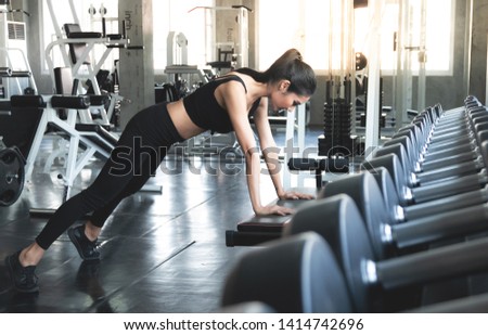 Beautiful women stretching exercise working out in gym alone