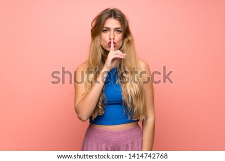 Young blonde woman over isolated pink background showing a sign of silence gesture putting finger in mouth