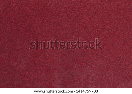 Red rough textured sandpaper background. Macro red sandpaper.
