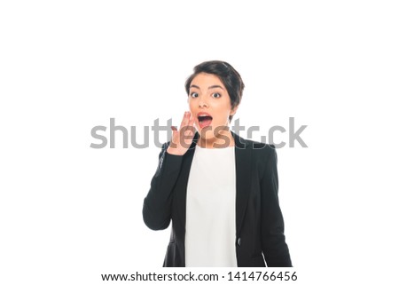 shocked mixed race businesswoman holding hand near face and looking at camera isolated on white