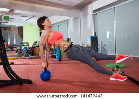 Crossfit fitness woman push ups with Kettlebell rear pushup exercise