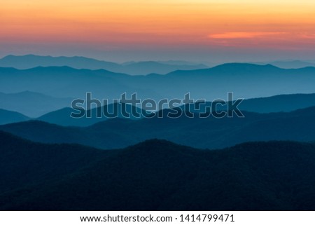 Scenic drive from Cowee Mountain Overlook on Blue Ridge Parkway at sunset time. Royalty-Free Stock Photo #1414799471