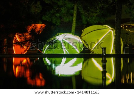 Colored umbrellas reflected in the water at night, Odessa, Ukraine