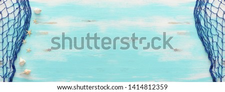Top view of Fishnet on pastel blue wooden background. top view, flat lay. banner