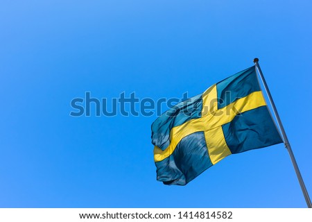 Swedish Flag on blue sky. Swedish Flag Day concept.  Sveriges nationaldag. National Day of Sweden. 
